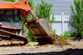 Mini bulldozer with earth doing landscaping works Royalty Free Stock Photo