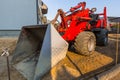 Mini bulldozer parked at the ouse for ground work Royalty Free Stock Photo