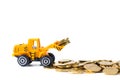 Mini bulldozer truck loading stack coin with pile of gold coin, Royalty Free Stock Photo