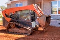 Mini bulldozer working with earth, moving soil doing landscaping Royalty Free Stock Photo