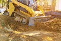 Mini bulldozer working with earth soil while doing landscaping works on construction Royalty Free Stock Photo