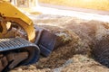 Mini bulldozer working with earth soil while doing landscaping works on construction Royalty Free Stock Photo