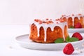 Mini Bundt cake with lemon sugar icing and freeze-dried strawberry Royalty Free Stock Photo