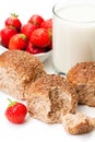 Mini buns and mug of milk with strawberries isolated on white b