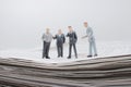 mini of business maen on Pile of newspapers on background Royalty Free Stock Photo