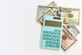 Mini calculator and US 100 and 50 dollars on white background. American cash, savings, taxes, benefit, income, money, finance