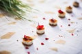 mini camembert bites on parchment, red chili garnish