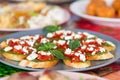 Mini canapes with green avocado paste, tomato, red pepper, cream sauce and bread Royalty Free Stock Photo