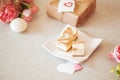 Mini cheese cake platter - caramel cheese cake on white plate with pink peomies and brown paper wrapped present