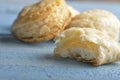 Mini cheese filled baked pies isolated on blue wooden background