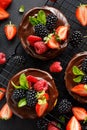 Mini cheesecake covered with chocolate with the addition of fresh berry fruits: blackberry, raspberry, strawberry, cherry and mint Royalty Free Stock Photo