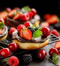 Mini cheesecake covered with chocolate with the addition of fresh berry fruits: blackberry, raspberry, strawberry, cherry and mint Royalty Free Stock Photo