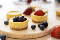 Mini cheesecake decorated with blueberry, blackberry and strawberry