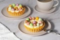 Mini cheesecakes with candy eggs and whipped cream Royalty Free Stock Photo