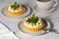 Mini cheesecakes with candy eggs and whipped cream. Pastel colored Easter dessert Royalty Free Stock Photo