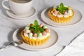 Mini cheesecakes with candy eggs and whipped cream. Pastel colored Easter dessert Royalty Free Stock Photo