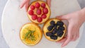 Mini cheesecakes close-up. Topping cheesecakes with orange marmalade, fresh berries, and rosemary Royalty Free Stock Photo