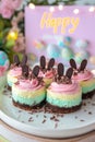 Mini cheesecakes decorated with Easter candy eggs and whipped cream Royalty Free Stock Photo