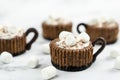 Mini chocolate cheesecake decorated with whipped cream and marshmallow