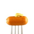 Mini cocktail sausages on fork with mustard