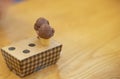 Mini cone with chocolate ice cream on hole box package on wooden