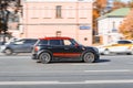 Mini Cooper ALL4 on the city road. Fast moving black car on Moscow streets. Vehicle driving on the street in city with blurred