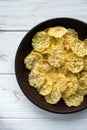 Mini corn bread with salt and olive herbs in a clay plate on a white board. Corn cakes. Healthy cereal snacks. Proper nutrition