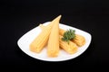 Mini Corn cob preserved on plate black background. Royalty Free Stock Photo