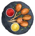 Mini corn dogs on a black board with sauces Royalty Free Stock Photo