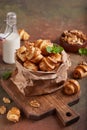 Mini croissant cookies with walnuts and brown sugar, served with milk