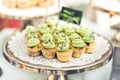 Mini cupcakes with green icing on a silver tray