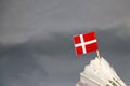 Mini Denmark flag stick on the white shuttlecock on the grey background