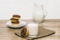 Mini donuts covered with chocolate glaze served with bottle, jug, glass of milk. Stack of tasty sweet sugar creamy or icing