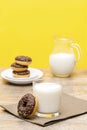 Mini donuts covered with chocolate glaze served with bottle, jug, glass of milk. Stack of tasty sweet sugar creamy or Royalty Free Stock Photo