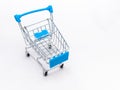 Mini empty grocery cart isolated on white background