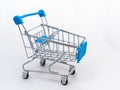 Mini empty grocery cart isolated on white background