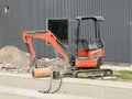 Mini excavator with construction equipment at work for replacement the cables or pipelines underground. No people Royalty Free Stock Photo