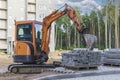 Mini excavator at the construction site. Compact construction equipment for earthworks Royalty Free Stock Photo