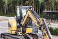 Mini excavator at the construction site. Compact construction equipment for earthworks Royalty Free Stock Photo