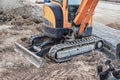 Mini excavator at the construction site. Compact construction equipment for earthworks Royalty Free Stock Photo