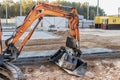 Mini excavator at the construction site. Compact construction equipment for earthworks Royalty Free Stock Photo