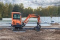 Mini excavator at the construction site. Compact construction equipment for earthworks Royalty Free Stock Photo