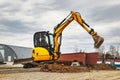 Mini excavator at the construction site. Compact construction equipment for earthworks. An indispensable assistant for earthworks Royalty Free Stock Photo