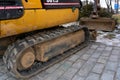 Mini excavator on the construction site. Replacement of paving slabs and repair of roads in the city. Crawler excavator with a