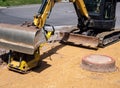 Mini excavator in road construction site Royalty Free Stock Photo