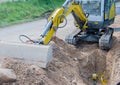 Mini excavator for road works for internet and power supply Royalty Free Stock Photo