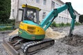 Mini excavator works on road repair