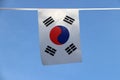 Mini fabric rail flag of South Korea, a white rectangular background, a red and blue Taeguk, symbolizing balance. Royalty Free Stock Photo