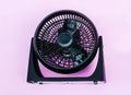 Mini fan ,Electric light black plastic fan on pink pastel background with copy space Royalty Free Stock Photo