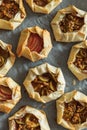 Mini Fig and Apple Galettes with Nuts on Parchment Background Royalty Free Stock Photo